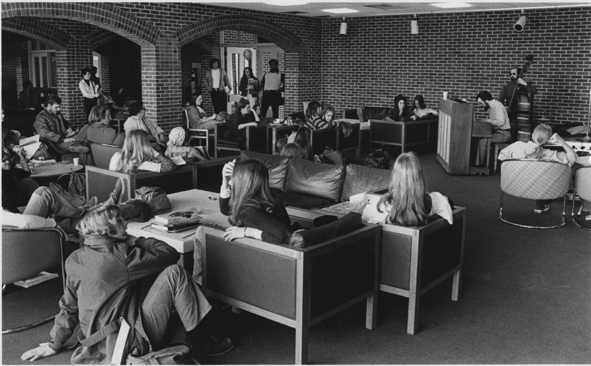 Students listening to music being performed in Campus Center lounge, ca. 1977.